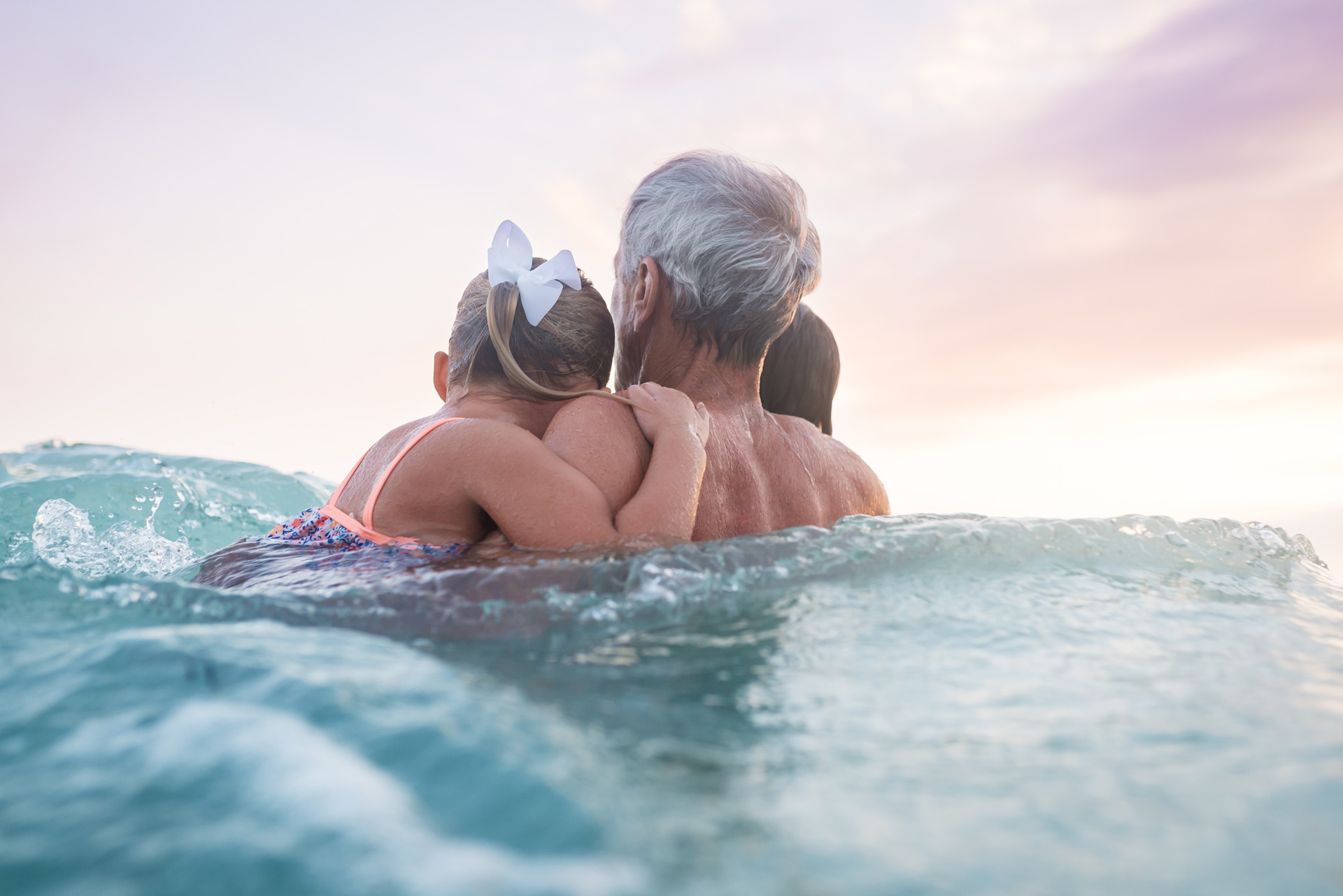 Grandpa with children in water